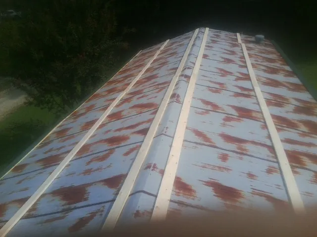 Rusted metal roof panels with new wood purlins before replacement — Storm Damage Roof Repair in Normandy by Roofing Brothers